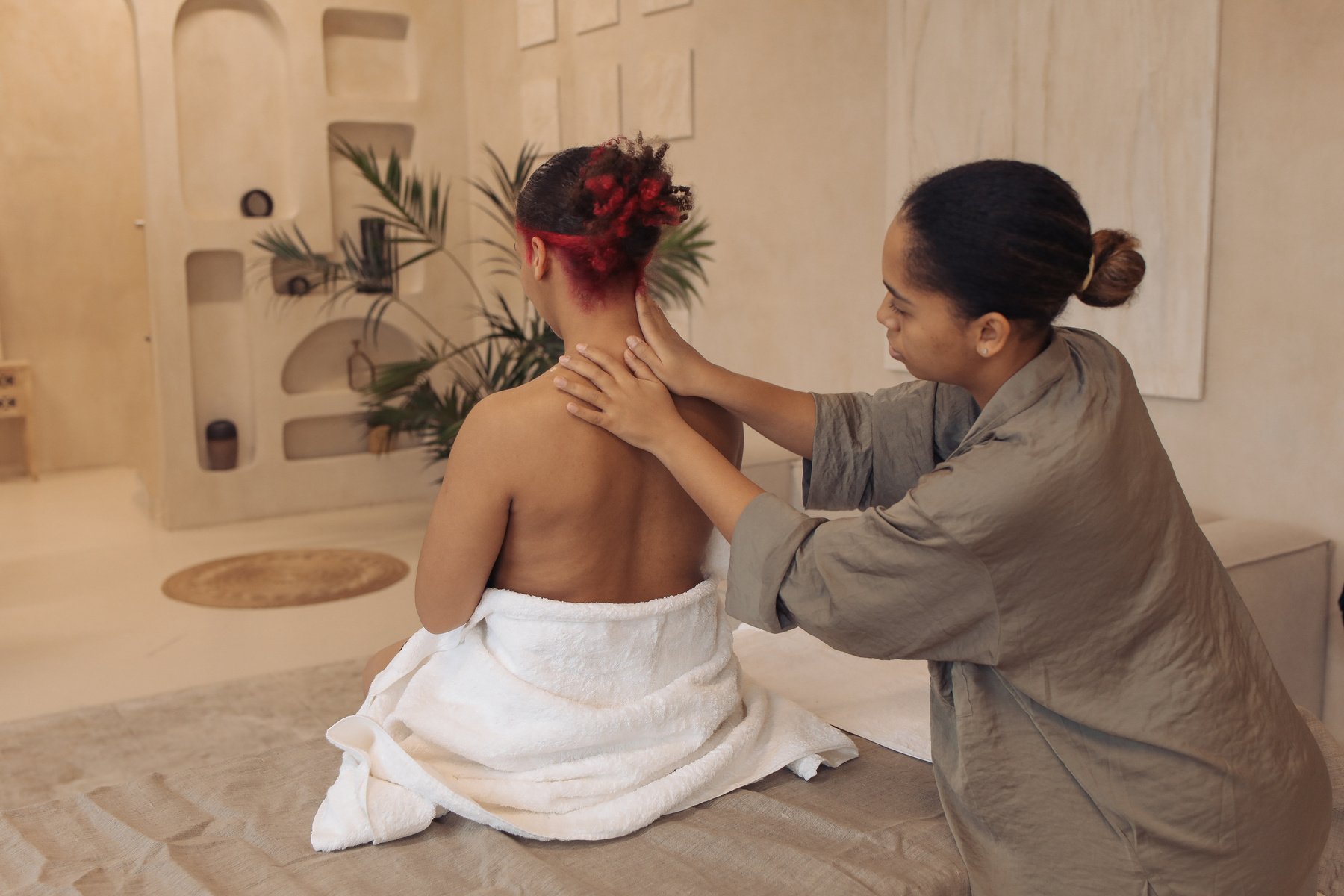 Masseuse Massaging Woman's Back